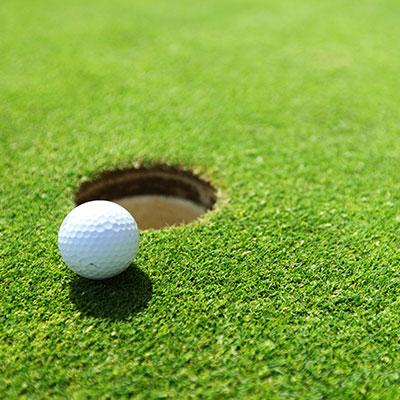 Closeup of a golf ball on the greens