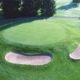 Aerial view of a golf hole with a red flag